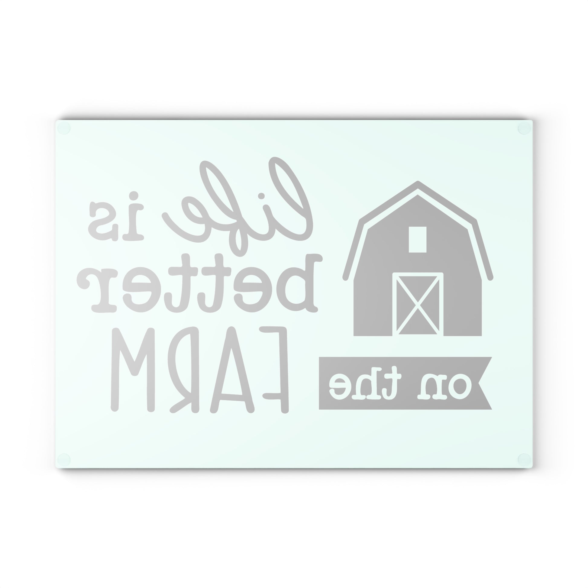 reverse image of a glass cutting board with the words "life is better on the farm" on a white background