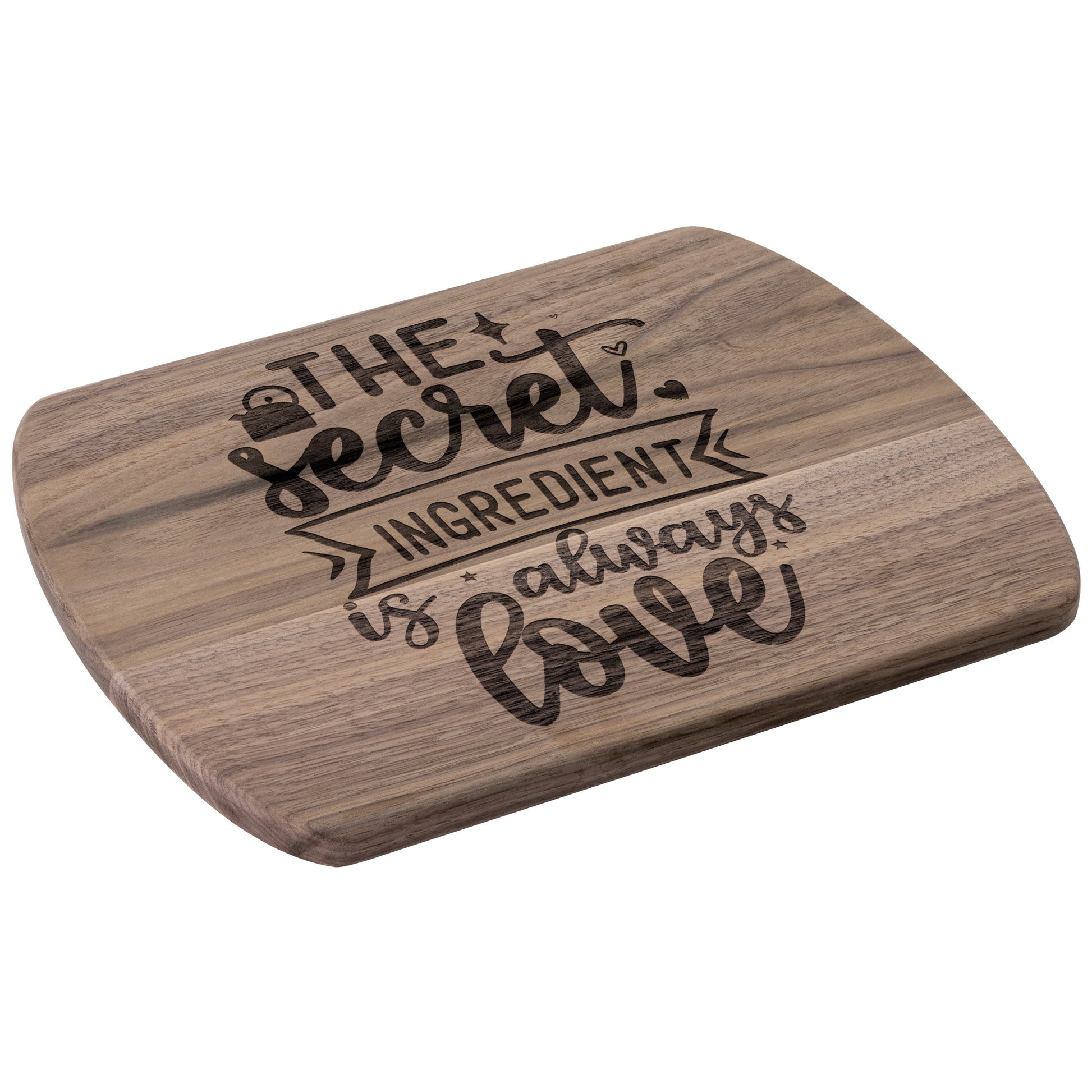angled view of walnut cutting board with the words "the secret ingredient is always love" on a white background