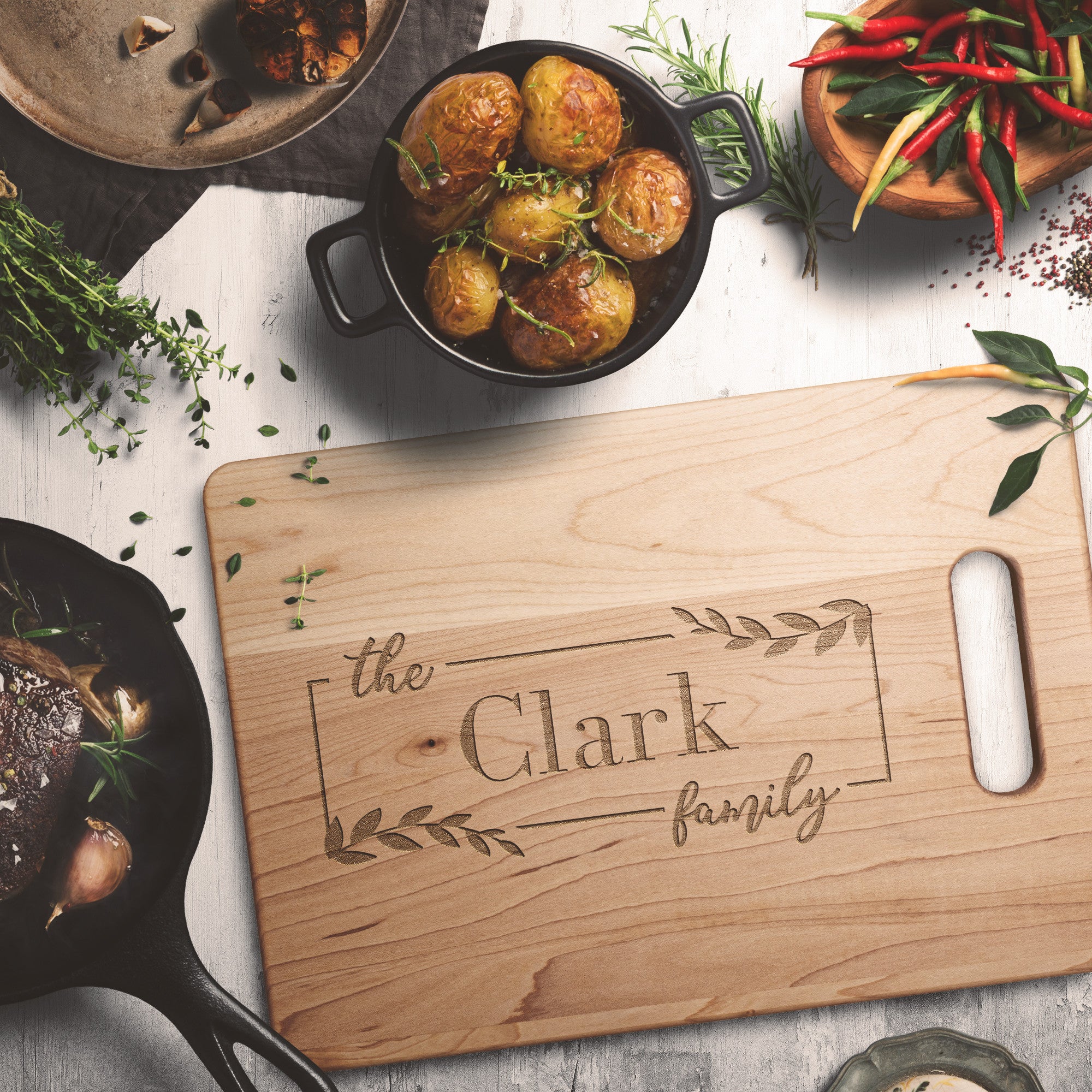 Personalized maple cutting board on table with potatoes and peppers