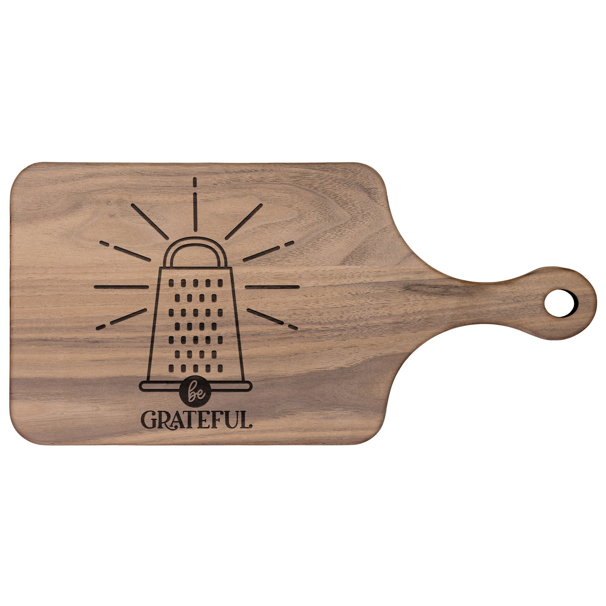 a walnut cutting board with a cheese grater with the words "be grateful" engraved on the cutting board on a white background