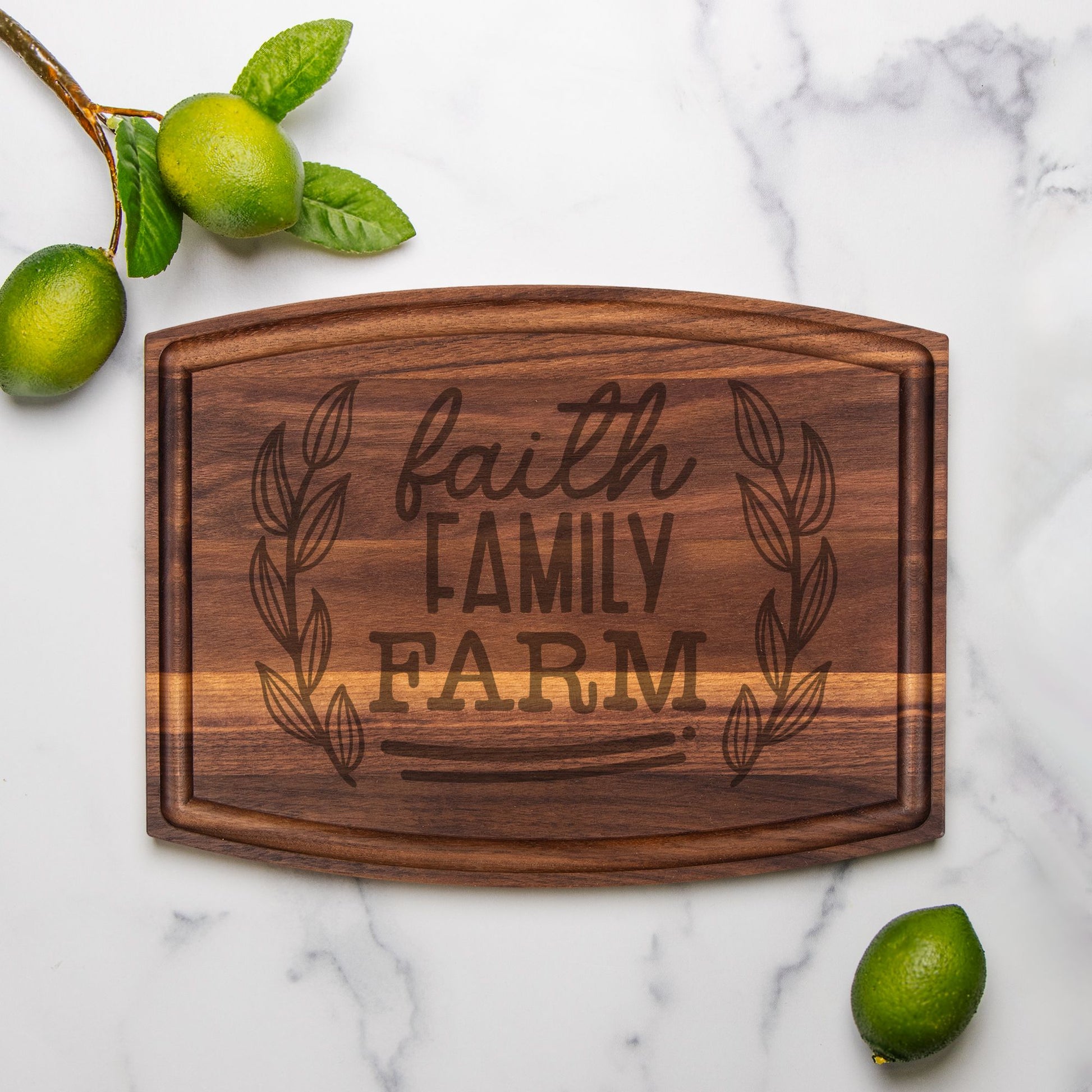 image of walnut cutting board on marble countertop with limes as decoration