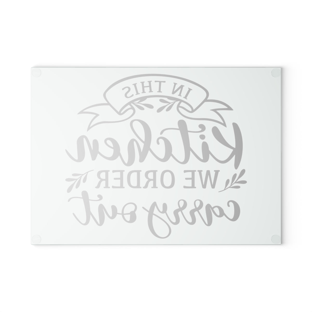 reverse view of a glass cutting board with the words "in this kitchen we order carry out" on a white background