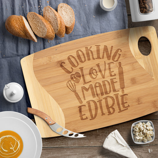Picture of bamboo cutting board with the words "Cooking is love made Edible" on brown table with sliced bread as decor 